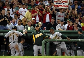BOSTON - JULY 06:  Nomar Garciaparra #1 of the Oakland Athletics is congratulated by teammates in the dugout after he hit a single against the Boston Red Sox on July 6, 2009 at Fenway Park in Boston, Massachusetts. Garicaparra was pulled and Rajai Davis  