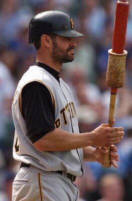 CHICAGO - APRIL 15:  Jason Kendall #18 of the Pittsburgh Pirates warms up prior to his at-bat during the game against the Chicago Cubs on April 15, 2004 at Wrigley Field in Chicago, Illinois.  The Cubs defeated the Pirates 10-5.  (Photo by Jonathan Daniel