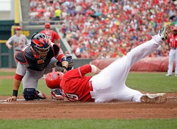 CINCINNATI - JULY 04:  Joey Votto #19 of the Cincinnati Reds is tagged out a home plate by Yadier Molina #4 of the St. Louis Cardinals at the Great American Ball Park on July 4, 2009 in Cincinnati, Ohio.  (Photo by Andy Lyons/Getty Images)