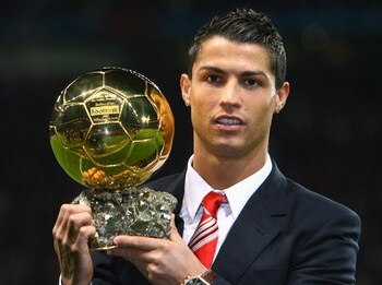 MANCHESTER, UNITED KINGDOM - DECEMBER 10:  Cristiano Ronaldo of Manchester United receives the Ballon d'or after being voted the European Footballer of the Year before the UEFA Champions League Group E match between Manchester United and Aalborg at Old Tr