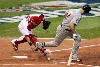 ST LOUIS, MO - JULY 14:  National League All-Star Yadier Molina #4 of the St. Louis Cardinals fields a bunt off the bat of American League All-Star Joe Mauer #7 of the Minnesota Twins during the 2009 MLB All-Star Game at Busch Stadium on July 14, 2009 in 
