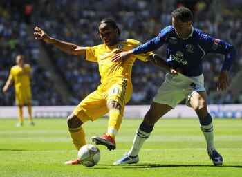 LONDON, ENGLAND - MAY 30: Didier Drogba of Chelsea is challenged by Joleon Lescott of Everton during the FA Cup sponsored by E.ON Final match between Chelsea and Everton at Wembley Stadium on May 30, 2009 in London, England.  (Photo by Shaun Botterill/Get