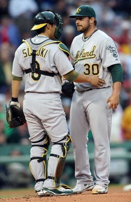 BOSTON - JULY 07:  Dana Eveland #30 of the Oakland Athletics is consoled by Kurt Suzuki #8 after Eveland loaded up the bases in the second inning against the Boston Red Sox on July 7, 2009 at Fenway Park in Boston, Massachusetts.  (Photo by Elsa/Getty Ima