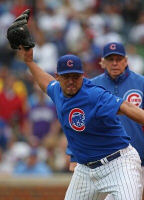 CHICAGO - MAY 27: Starting pitcher Carlos Zambrano #38 of the Chicago Cubs throws his glove into the dugout after being thrown out of a game in the 7th inning against the Pittsburgh Pirates as pitching coach Larry Rothschild watches on May 27, 2009 at Wri