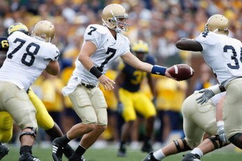 ANN ARBOR, MI - SEPTEMBER 15:  Jimmy Clausen #7 hands off to James Aldridge #34 of the Notre Dame Fighting Irish during the game against the Michigan Wolverines on September 15, 2007 at Michigan Stadium in Ann Arbor, Michigan. Michigan won 38-0. (Photo by