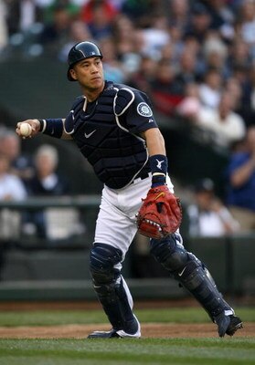 SEATTLE - MAY 22:  Catcher Kenji Johjima #2 of the Seattle Mariners fields an infield ball during the game against the San Francisco Giants on May 22, 2009 in Seattle, Washington. The Mariners defeated the Giants 2-1 in twelve innings. (Photo by Otto Greu