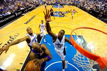 ORLANDO, FL - JUNE 14:  Lamar Odom #7 of the Los Angeles Lakers goes to the basket against Rashard Lewis #9 and Dwight Howard #12 of the Orlando Magic in Game Five of the 2009 NBA Finals on June 14, 2009 at Amway Arena in Orlando, Florida.  NOTE TO USER: 
