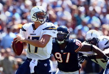 SAN DIEGO - SEPTEMBER 9:  Starting Quarterback Philip Rivers #17 of the San Diego Chargers is sacked by Mark Anderson #97 and Darwin Walker #99 of the Chicago Bears at Qualcomm Stadium September 9, 2007 in San Diego, California.  (Photo by Donald Miralle/