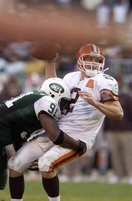 EAST RUTHERFORD, NJ - OCTOBER 27:  Quarterback Tim Couch #2 of the Cleveland Browns is hit by Josh Evans #91 of the New York Jets as Couch throws the ball during the game at Giant Stadium on October 27, 2002 in East Rutherford, New Jersey. Couch was still