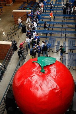 NEW YORK - APRIL 03:  Fans line up to be photographed next to the original Home Run Apple before an exhibition game between the New York Mets and  the Boston Red Sox on April 3, 2009 at Citi Field in the Flushing neighborhood of the Queens borough of New 
