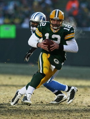 GREEN BAY, WI - DECEMBER 28: Aaron Rodgers #12 of the Green Bay Packers breaks away from Cliff Avril #92 of the Detroit Lions on December 28, 2008 at Lambeau Field in Green Bay, Wisconsin. The Packers defeated the Lions 31-21. (Photo by Jonathan Daniel/Ge