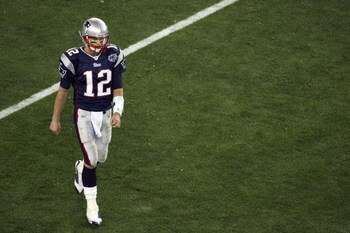 GLENDALE, AZ - FEBRUARY 03:  Tom Brady #12 of the New England Patriots walks off the field against the New York Giants in Super Bowl XLII on February 3, 2008 at the University of Phoenix Stadium in Glendale, Arizona.  (Photo by Jim McIsaac/Getty Images)