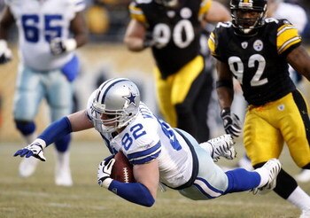 PITTSBURGH - DECEMBER 07: Jason Witten #82 of the Dallas Cowboys dives for a first quarter first down in front of James Harrison #92 of the Pittsburgh Steelers on December 7, 2008 at Heinz Field in Pittsburgh, Pennsylvania.  (Photo by Gregory Shamus/Getty