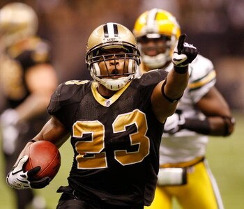 NEW ORLEANS - NOVEMBER 24:  Pierre Thomas #23 of the New Orleans Saints celebrates after scoring a touchdown in the fourth quarter around Nick Collins #36 of the Green Bay Packers on November 24, 2009 at the Superdome in New Orleans, Louisiana.  (Photo by
