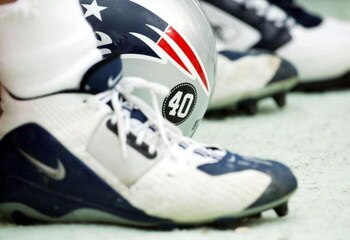 TEMPE, AZ - SEPTEMBER 19:  A New England Patriots helmet bearing a decal with the number 40 of the late Pat Tillman rests between a players shoes during a game against the Arizona Cardinals at Sun Devil Stadium on September 19, 2004 in Tempe, Arizona. The