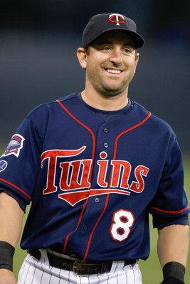 MINNEAPOLIS, MN - JULY 9:  Shortstop Nick Punto #8 of the Minnesota Twins smiles as he walks off the field against the New York Yankees at Hubert H. Humphrey Metrodome on July 9, 2008 in Minneapolis, Minnesota. The Yankees defeated the Twins 6-4. (Photo b