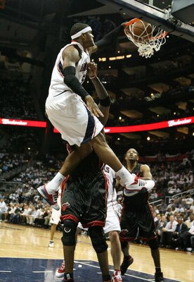 ATLANTA - APRIL 29:  Josh Smith #5 of the Atlanta Hawks dunks over and is fouled by Jermaine O'Neal #7 of the Miami Heat during Game Five of the Eastern Conference Quarterfinals at Philips Arena on April 29, 2009 in Atlanta, Georgia. The Hawks defeated th