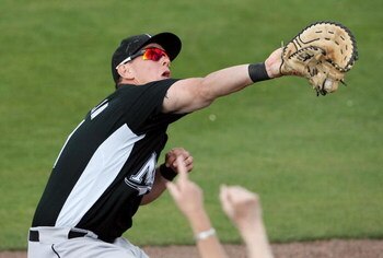JUPITER, FL - FEBRUARY 25: First baseman Logan Morrison #81 of the Florida Marlins reaches into the stands to make a catch against the St. Louis Cardinals during a spring training game at Roger Dean Stadium February 25, 2009 in Jupiter, Florida.  (Photo b