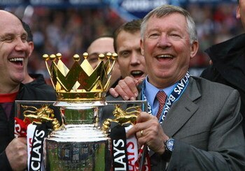 MANCHESTER, ENGLAND - MAY 16:  Manchester United Manager Sir Alex Ferguson (R) and Assistant Mike Phelan celebrate with the Barclays Premier League trophy after their side won the Premier League title at the end of the Barclays Premier League match betwee