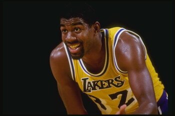 Guard Magic Johnson of the Los Angeles Lakers stands on the court during a game at the Great Western Forum in Inglewood, California.