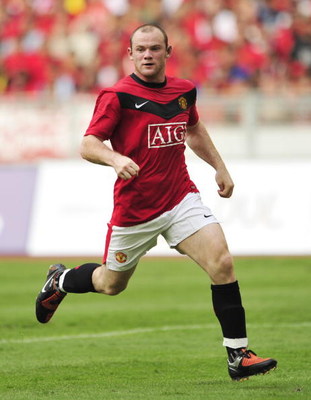 KUALA LUMPUR, MALAYSIA - JULY 18: Wayne Rooney of Manchester United runs for the ball during the pre-season friendly match between Manchester United and Malaysia XI at the Bukit Jalil National Stadium on July 18, 2009 in Kuala Lumpur, Malaysia. (Photo by