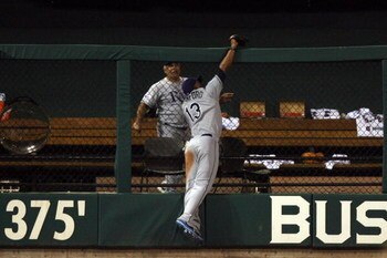 ST LOUIS, MO - JULY 14:  American League All-Star Carl Crawford of the Tampa Bay Rays robs a home run from National League All-Star Brad Hawpe of the Colorado Rockies during the 2009 MLB All-Star Game at Busch Stadium on July 14, 2009 in St Louis, Missour