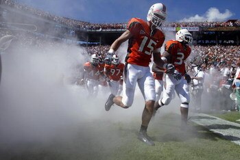 MIAMI - OCTOBER 12:   Quarterback Buck Ortega #15 of Miami takes the field as he emerges from the fog before the game against Florida State on October 12, 2002 at the Orange Bowl in Miami, Florida.  Miami edged Florida State 28-27.  (Photo by Andy Lyons/G