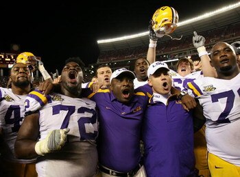 TUSCALOOSA, AL - NOVEMBER 03:  Glenn Dorsey #72, Larry Porter, head coach Les Miles and Ciron Black #70 of the LSU Tigers celebrate after defeating the Alabama Crimson Tide at Bryant-Denny Stadium on November 3, 2007 in Tuscaloosa, Alabama. LSU defeated A