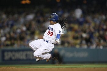 LOS ANGELES, CA - JULY 16:  Manny Ramirez #99 of the Los Angeles Dodgers slides into second base during the game against the Houston Astro's on July 16, 2009 at Dodger Stadium in Los Angeles, California.  (Photo by Stephen Dunn/Getty Images)