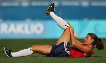 HERAKLIO, GREECE - AUGUST 23:  Mia Hamm of USA stretches prior to the women's football semifinal match between USA and Germany on August 23, 2004 during the Athens 2004 Summer Olympic Games at Pankritio Stadium in Heraklio, Greece. (Photo by Scott Barbour