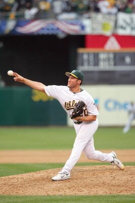 OAKLAND, CA - OCTOBER 6: Huston Street #20 of the Oakland Athletics pitches against the Minnesota Twins in game three of the American League Division Series at McAfee Coliseum on October 6, 2006 in Oakland, California. (Photo by Jed Jacobsohn/Getty Images