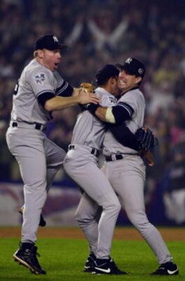 26 Oct 2000:  Third baseman Scott Brosius, left, Mariano Rivera and Tino Martinez of the New York Yankees celebrate the last out against the New York Mets to win Game 5 and their third consecutive World Series Championship at Shea Stadium in Flushing, New