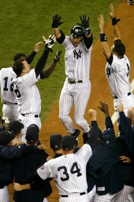 BRONX, NY - OCTOBER 17:  Aaron Boone #19 of the New York Yankees is greeted by his teammates at home plate after a he hit the game winning homerun in the 11th inning off of Tim Wakefield of the Boston Red Sox as the Yankees defeated the Red Sox 6-5 in gam