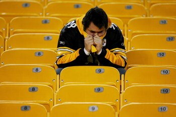 PITTSBURGH - JANUARY 05: A Pittsburgh Steelers fans sits in the stands after the Steelers lost to the Jacksonville Jaguars in the AFC Wild Card game on January 5, 2008 at Heinz Field in Pittsburgh, Pennsylvania.  The Jaguars won 31-29.  (Photo by Chris Mc