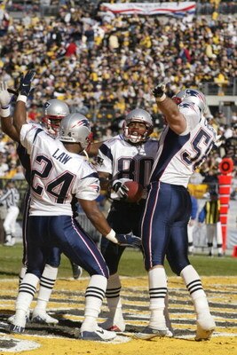 27 Jan 2002: Troy Brown #80 of the New England Patriots celebrates his return punt for a touchdown against the Pittsburgh Steelers with teammates Ty Law #24 and Matt Chatham during the AFC Championship Game at Heinz Field in Pittsburgh, Pennsylvania. The 