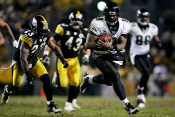 PITTSBURGH - JANUARY 05:  David Garrard #9 of the Jacksonville Jaguars runs out of the grasp of Tyrone Carter #23 of the Pittsburgh Steelers the set up the game-winning field goal during the fourth quarter of the AFC Wild Card game on January 5, 2008 at H