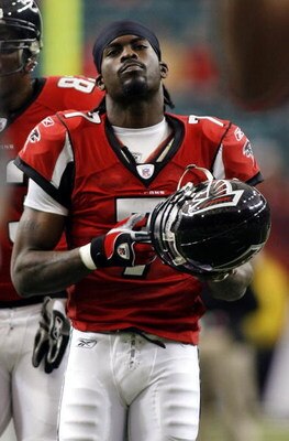 ATLANTA - DECEMBER 24:   Quarterback Michael Vick #7 of the Atlanta Falcons walks off against the Carolina Panthers December 24, 2006 at The Georgia Dome  in Atlanta,Georgia  (Photo by Marc Serota/Getty Images)