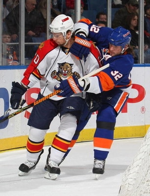 UNIONDALE, NY - JANUARY 31: Richard Zednik #20 of the Florida Panthers is held by Brendan Witt #32 of the New York Islanders on January 31, 2009 at Nassau Coliseum in Uniondale, New York. (Photo by Bruce Bennett/Getty Images)