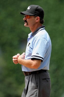 DENVER - JULY 20:  Umpire Bill Hohn oversees the action at first base between the Pittsburgh Pirates and the Colorado Rockies at Coors Field on July 20, 2008 in Denver, Colorado. The Rockies defeated the Pirates 11-3.  (Photo by Doug Pensinger/Getty Image