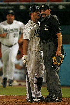 MIAMI - JUNE 9: Cody Ross #12 of the Florida Marlins argues with Home Plate Umpire Bill Hohn and gets tossed from the game in the 8th inning against the Cincinnati Reds on June 9, 2008 at Dolphin Stadium in Miami, Florida. (Photo by Eliot J. Schechter/Get