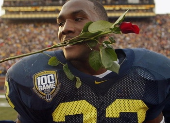 ANN ARBOR, MI - NOVEMBER 22:  Running back Chris Perry #23 of the Michigan Wolverines celebrates by putting a rose in his mouth after the victory against the Ohio State Buckeyes during the 100th meeting of the two teams November 22, 2003 at Michigan Stadi