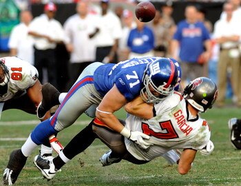 TAMPA, FL - JANUARY 06:  Defensive end Dave Tollefson #71 of the New York Giants sacks quarterback Jeff Garcia #7 of the Tampa Bay Buccaneers during the NFC Wild Card game at Raymond James Stadium on January 6, 2008 in Tampa, Florida.  The Giants won the 