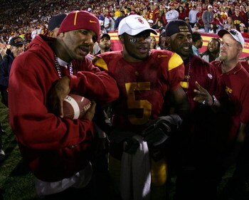 LOS ANGELES, CA - DECEMBER 03:  Hip-hop artist The Game (L) poses for a photo with Reggie Bush #5 of the USC Trojans against the UCLA Bruins December 3, 2005 at the Los Angeles Memorial Coliseum in Los Angeles, California. USC won 66-19. (Photo by Harry H