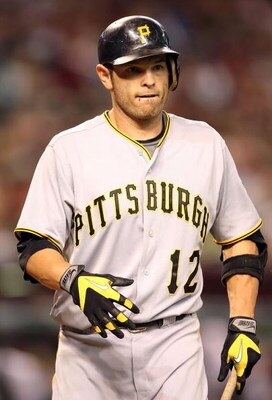 PHOENIX - JULY 25:  Freddy Sanchez #12 of the Pittsburgh Pirates walks back to the dugout after batting against the Arizona Diamondbacks during the major league baseball game at Chase Field on July 25, 2009 in Phoenix, Arizona. The Diamondbacks defeated t