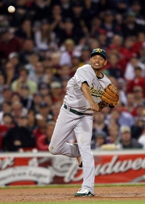 BOSTON - JULY 07:  Orlando Cabrera #18 of the Oakland Athletics sends the ball to first for the out in the seventh inning against the Boston Red Sox on July 7, 2009 at Fenway Park in Boston, Massachusetts.  (Photo by Elsa/Getty Images)
