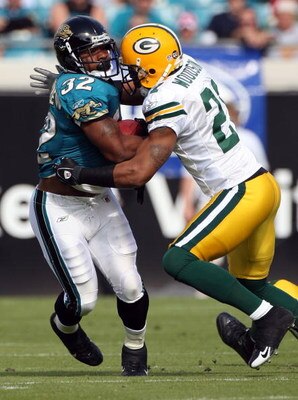 JACKSONVILLE, FL - DECEMBER 14:  Maurice Jones-Drew #32 of the Jacksonville Jaguars is tackled by Charles Woodson #21 of the Green Bay Packers during the game at Jacksonville Municipal stadium on December 14, 2008 in Jacksonville, Florida.  (Photo by Sam 