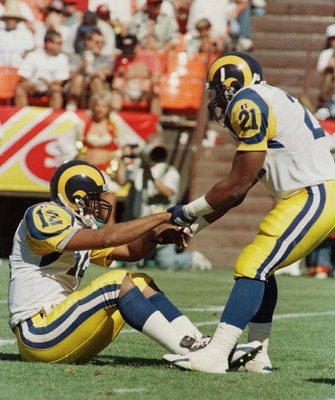 8 Sep 1996:  Running back Lawrence Phillips #21 of the St. Louis Rams picks up quarterback Tony Banks after being hit hard after the play during the Rams 34-0 loss to the San Francisco 49ers at 3Com Park in San Francisco, California. Mandatory Credit: Jed