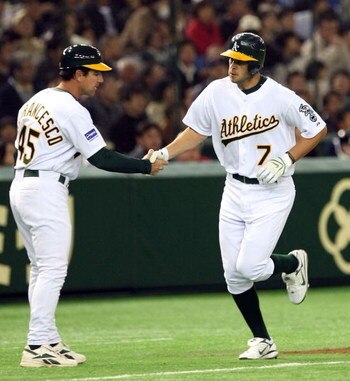TOKYO - MARCH 22:  Infielder Bobby Crosby #7 of Oakland Athletics shakes hands with coach Tony DeFrancesco #45 after his home run during preseason friendly game between Oakland Athletics and Yomiuri Giants at Tokyo Dome on March 22, 2008 in Tokyo, Japan. 