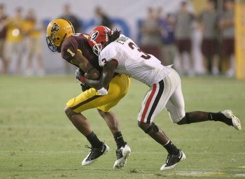 TEMPE, AZ - SEPTEMBER 20:  Wide receiver Michael Jones #1 of the Arizona State Sun Devils is tackled after a reception by corner back Bryan Evans #3 of the Georgia Bulldogs on September 20, 2008 at Sun Devil Stadium in Tempe, Arizona.  Georgia won 27-10. 