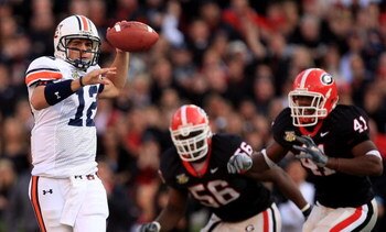 ATHENS, GA - NOVEMBER 10:  Brandon Cox #12 of the Auburn Tigers scrambles from teammates Geno Atkins #56 and Roderick Battle #41 of the Georgia Bulldogs during their game at Sanford Stadium November 10, 2007 in Athens, Georgia.  (Photo by Streeter Lecka/G